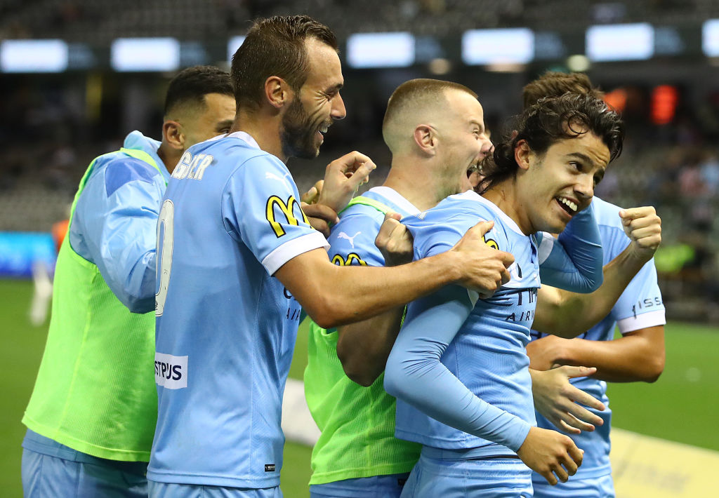Colacovski is embraced by his City teammates as he celebrates netting against Victory