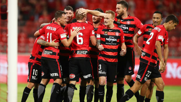 The Wanderers celebrate one of Brendon Santalab's two goals against the Phoenix on Sunday.