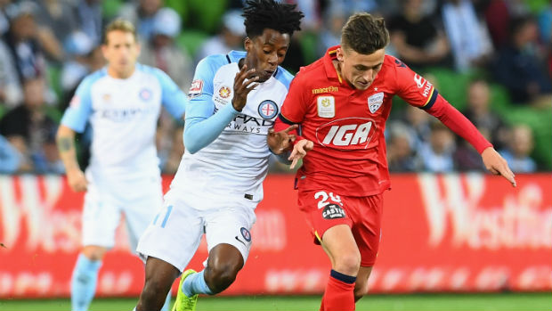 City's Bruce Kamau tries to win the ball from Adelaide's Jordan O'Doherty.