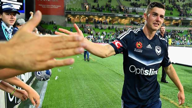 Melbourne Victory star Marco Rojas high-fives a fan after a match during the 2016/17 Season.