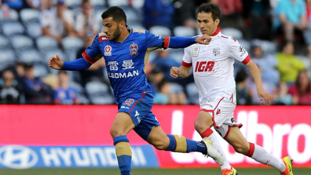 Jets midfielder Andrew Nabbout dribbles away from Adelaide's Isaias on Sunday.