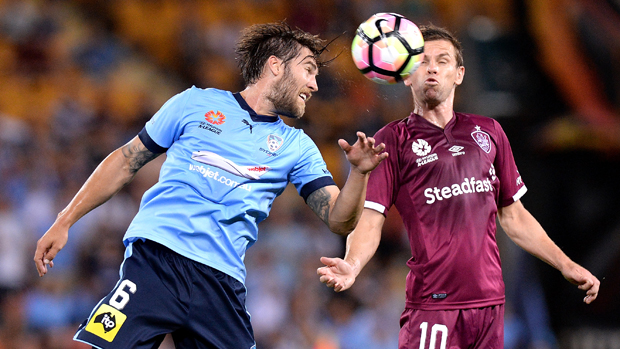 Sydney FC midfielder Josh Brillante challenges for the ball with Roar playmaker Brett Holman.