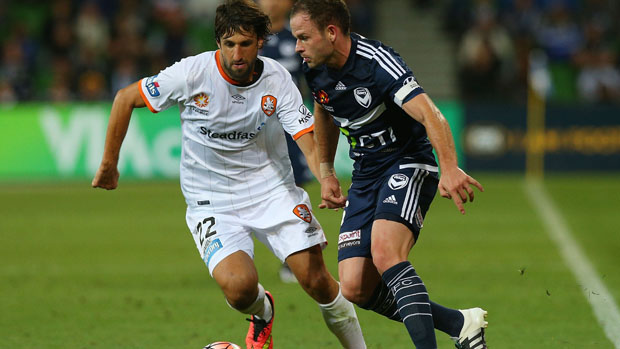 Roar star Thomas Broich fights for the ball with Victory midfielder Leigh Broxham.