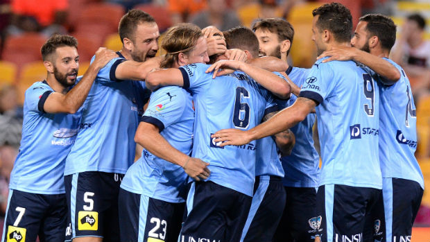 Sydney FC players celebrate their opener against Brisbane Roar on Saturday night.