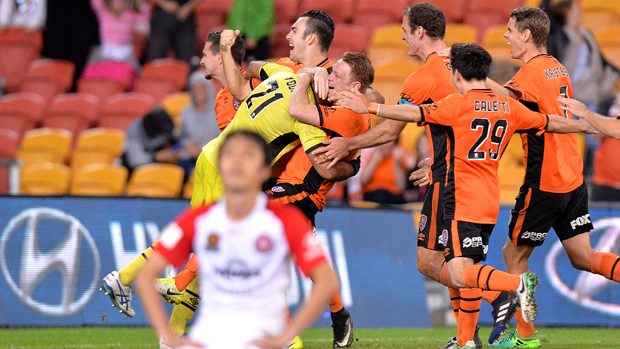 Roar players celebrate Jamie Young's decisive save in the penalty shootout.