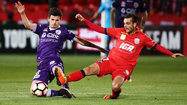 Perth Glory's Mitch Oxborrow and the Reds' Nikola Mileusnic involved in a full-blooded challenge at Coopers Stadium.
