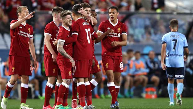 Liverpool players celebrate one of their three first half goals in the win over Sydney FC.