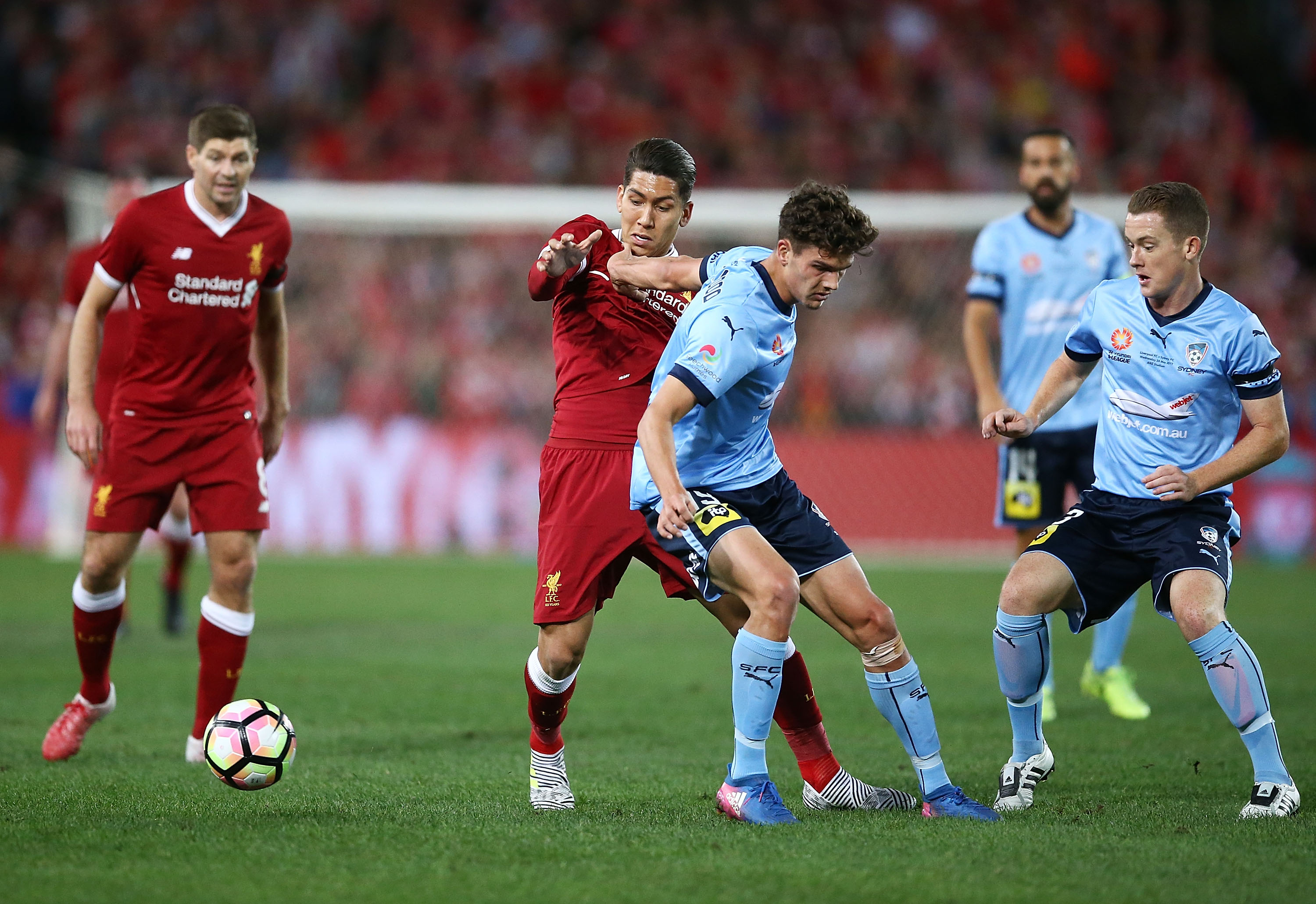 Roberto Firmino and George Blackwood battle for possession.