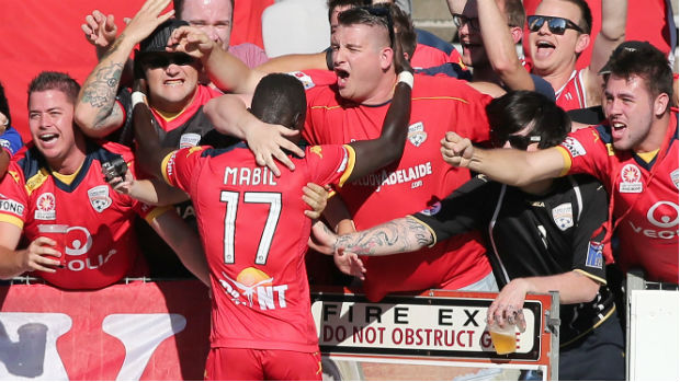 Adelaide youngster Awer Mabil celebrates his goal with the travelling Reds supporters.