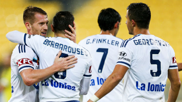 Melbourne Victory players celebrate Kosta Barbarouses' goal against the Phoenix on Saturday.