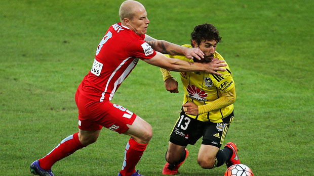 City star Aaron Mooy fights for the ball with Phoenix midfielder Albert Riera.