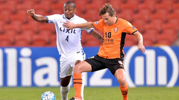 Brisbane Roar playmaker Brett Holman tries to hold off a Kashima defender in their ACL clash at Suncorp Stadium.