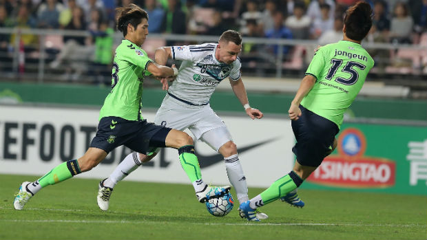 Victory striker Besart Berisha tries to beat a couple of Jeonbuk defenders in South Korea.
