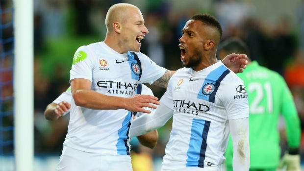 Melbourne City's Aaron Mooy and Harry Novillo celebrate squaring the ledger against Brisbane at AAMI Park.