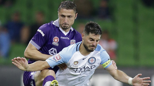 Glory defender Dino Djulbic fights for the ball with City captain Bruno Fornaroli.