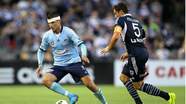 Sydney FC's Terry Antonis shields possession from Victory captain Mark Milligan.