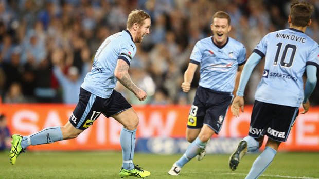Sydney FC players celebrate one of David Carney's two goals against Melbourne Victory.