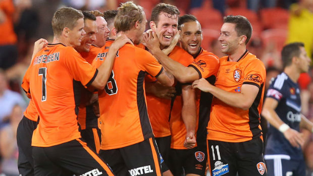 Brisbane Roar players celebrate their late equaliser against Victory at Suncorp Stadium.