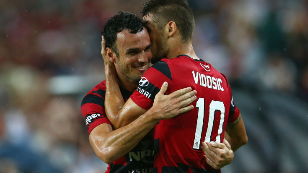 Mark Bridge and Dario Vidosic celebrate combining to open the scoring for the Wanderers in the Sydney Derby.