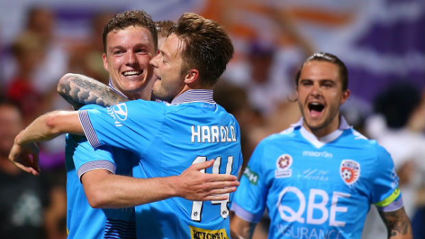 Glory's Shane Lowry and Chris Harold celebrate one of their side's six goals against the Roar at nib Stadium.