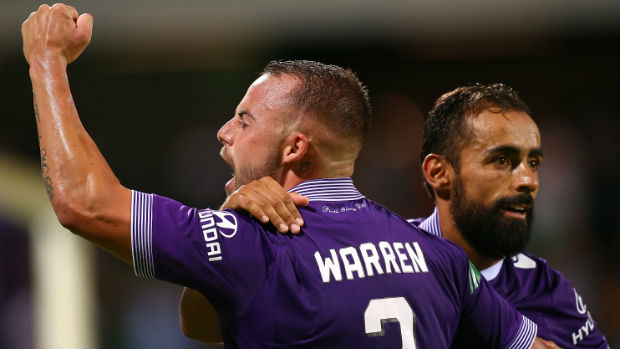 Perth Glory's Marc Warren and Diego Castro celebrate scoring against Melbourne Victory.