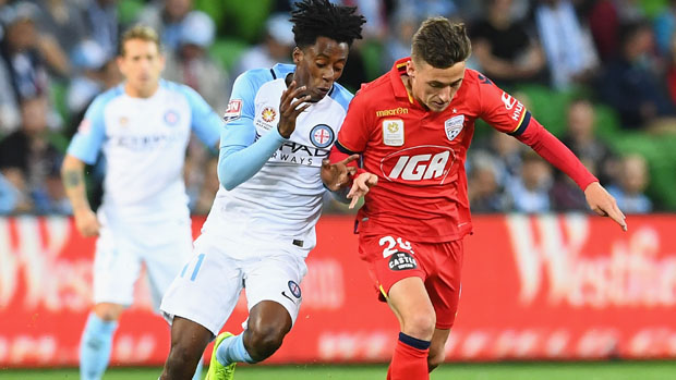 Adelaide United youngster Jordan O'Doherty challenges for the ball with City winger Bruce Kamau.