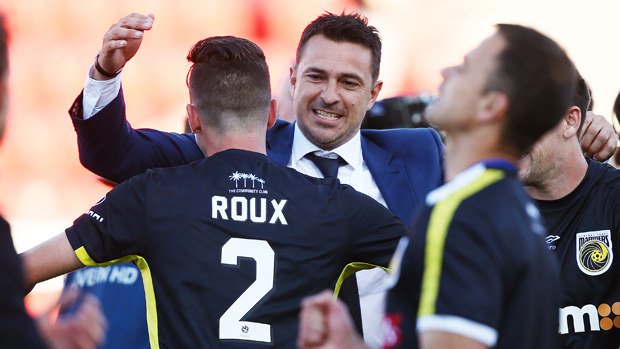 Paul Okon celebrates his first win as Mariners boss with fullback Storm Roux.