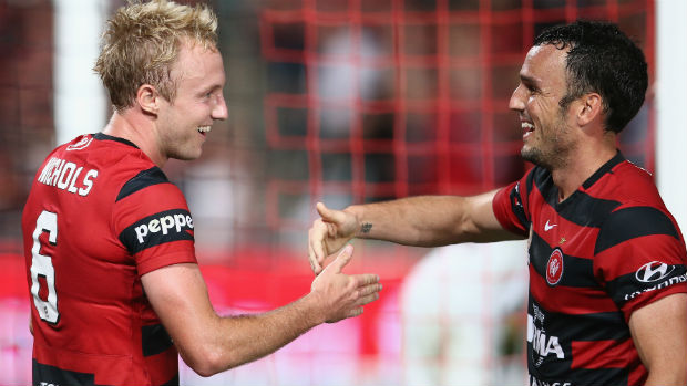 Mitch Nichols and Mark Bridge celebrate combining for the Wanderers' fourth goal against the Mariners.