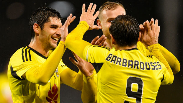 Wellington Phoenix's Gui Finkler, Hamish Watson and Kosta Barbarouses celebrate a goal in the FFA Cup.