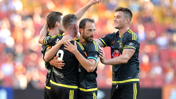 Wellington Phoenix players celebrate a goal in their 2-1 win over Brisbane Roar.